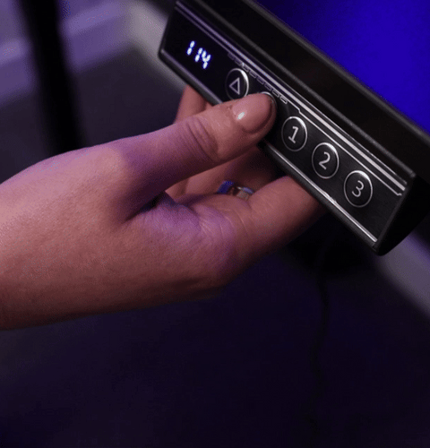 Modern black sit-stand desk with dual monitor setup